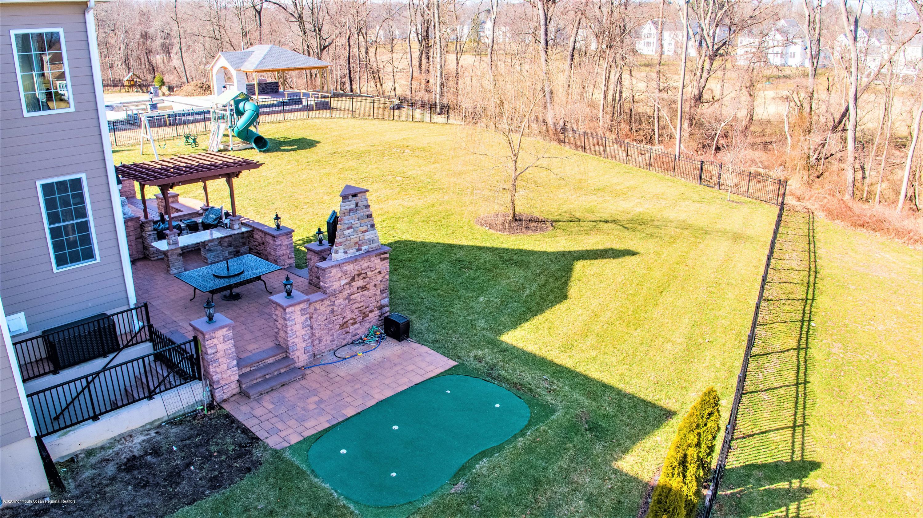 15 Windermere Road Lincroft, NJ 07738 - Photo 50 of 56 a view of a swimming pool with a yard