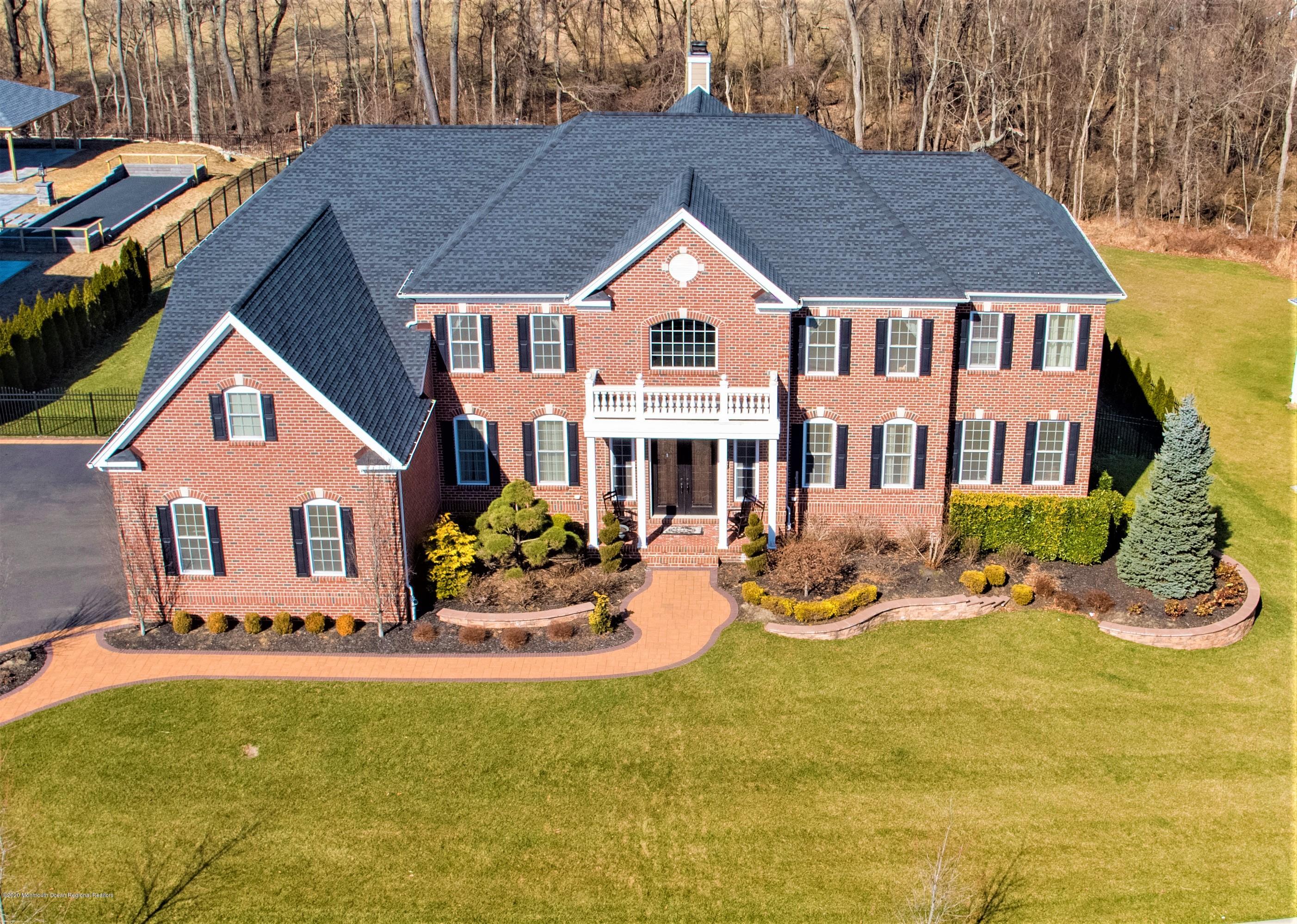 15 Windermere Road Lincroft, NJ 07738 - Photo 51 of 56 a front view of house with yard outdoor seating and barbeque oven