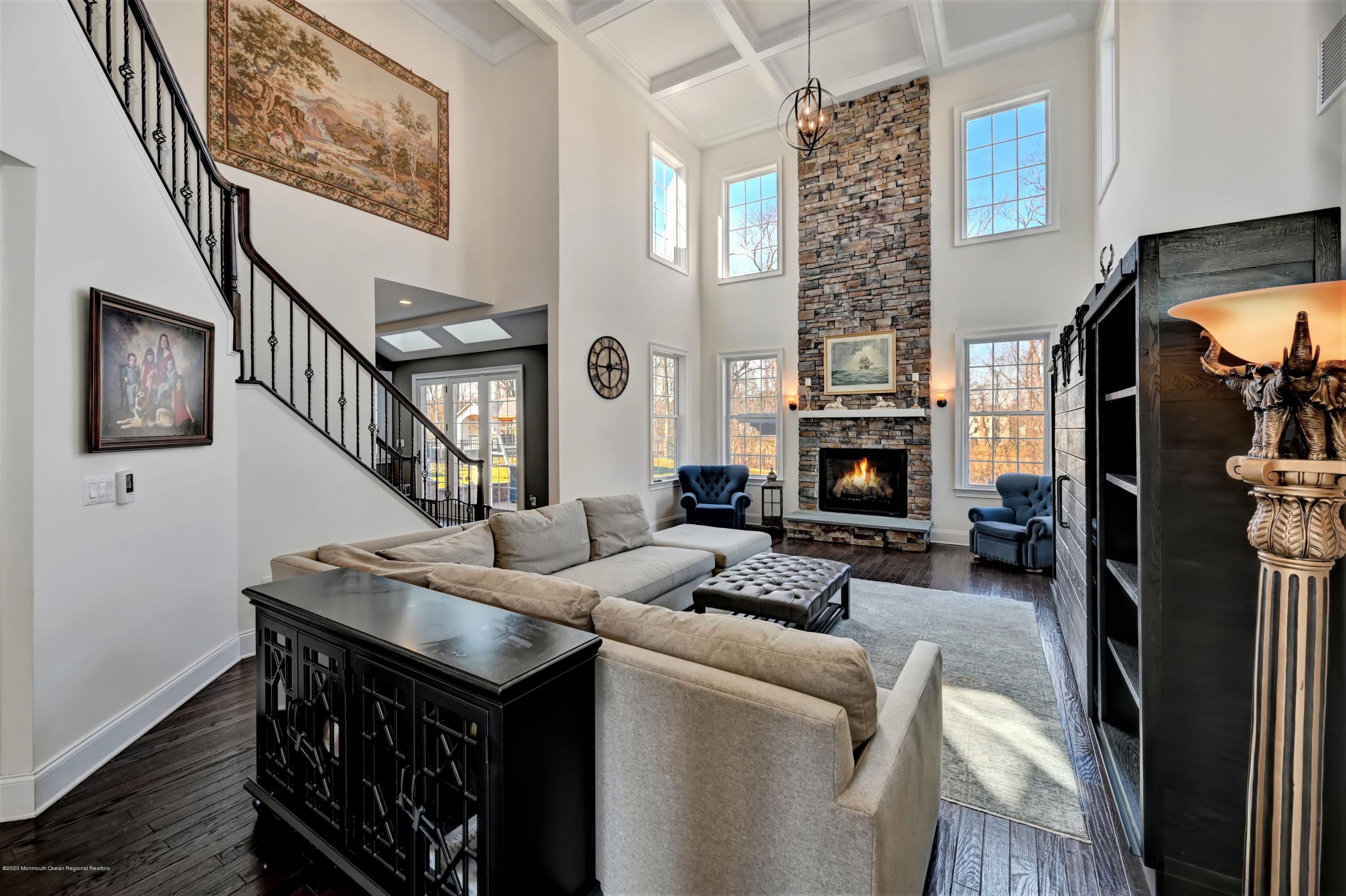 15 Windermere Road Lincroft, NJ 07738 - Photo 6 of 56 a living room with furniture a fireplace and a flat screen tv