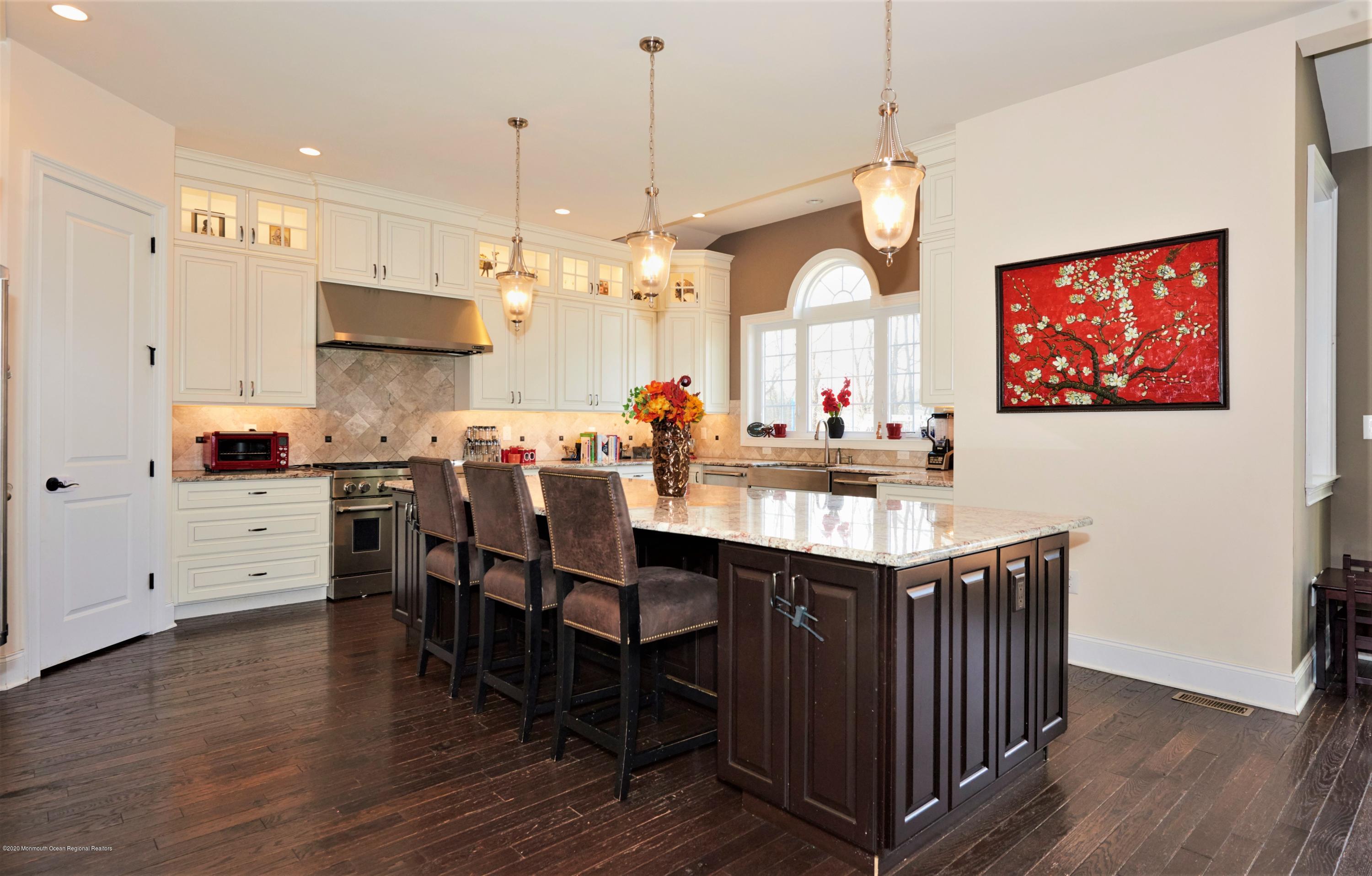 15 Windermere Road Lincroft, NJ 07738 - Photo 10 of 56 a kitchen with stainless steel appliances granite countertop a sink a stove and a refrigerator