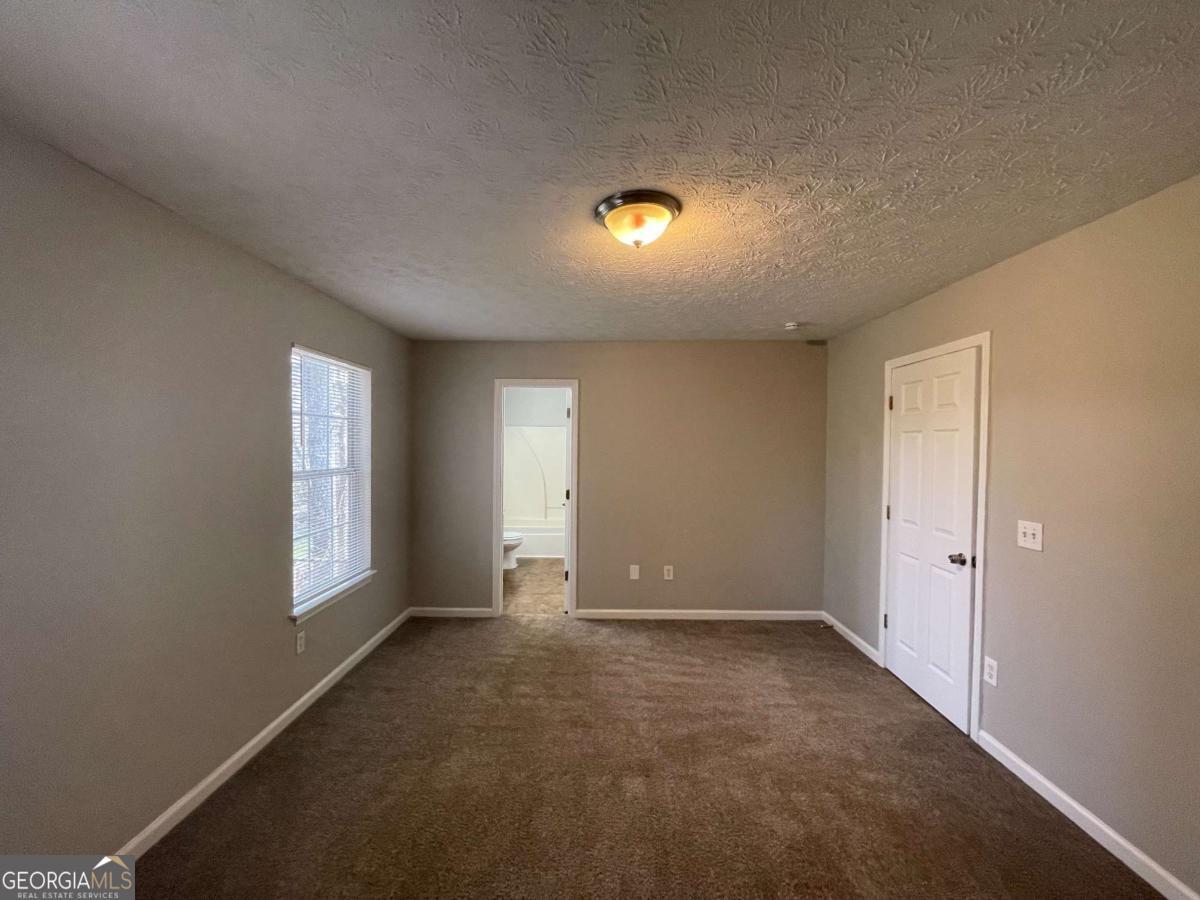 1374 To Lani Farm Road Stone Mountain, GA 30083 - Photo 11 of 18 a view of an empty room with a window
