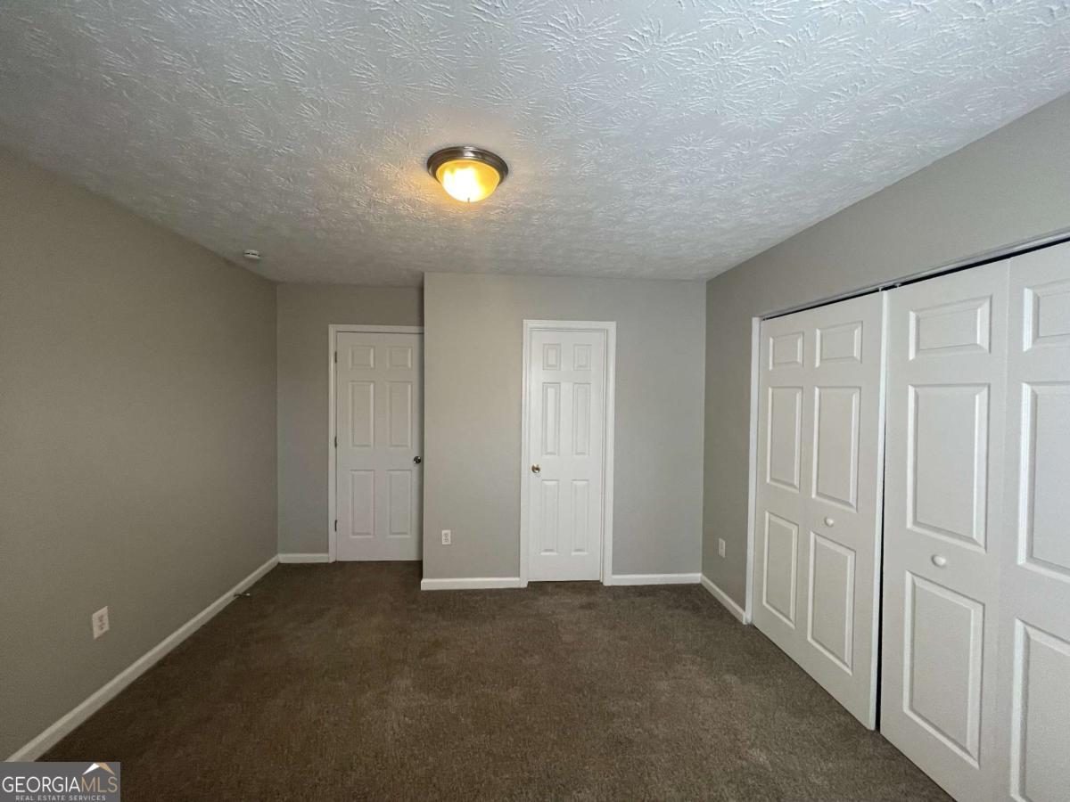 1374 To Lani Farm Road Stone Mountain, GA 30083 - Photo 14 of 18 an empty room with windows
