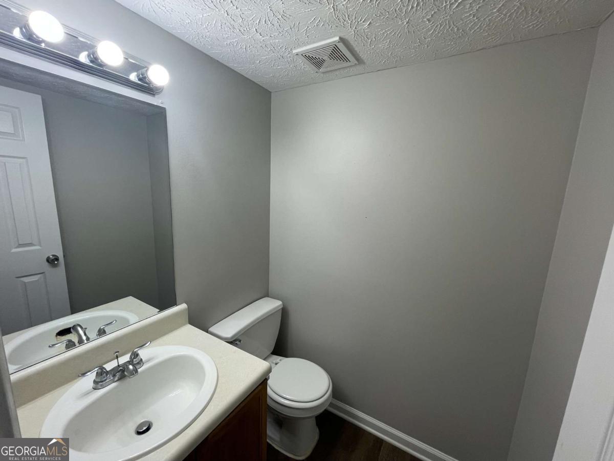 1374 To Lani Farm Road Stone Mountain, GA 30083 - Photo 15 of 18 a bathroom with a sink toilet and a mirror