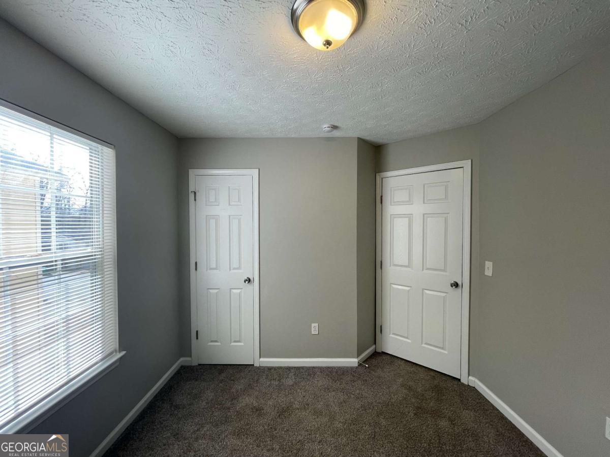 1374 To Lani Farm Road Stone Mountain, GA 30083 - Photo 16 of 18 an empty room with windows