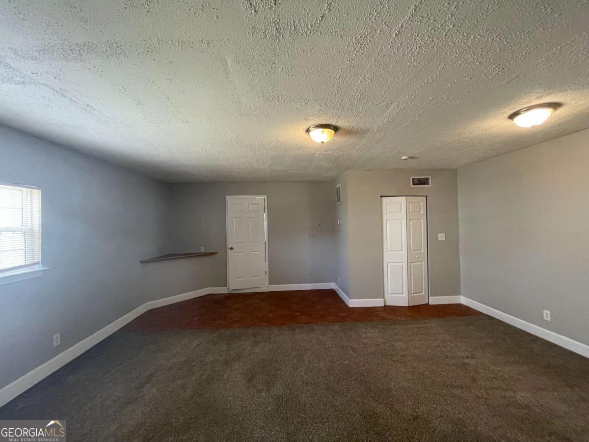 1374 To Lani Farm Road Stone Mountain, GA 30083 - Photo 6 of 18 an empty room with a empty space and windows