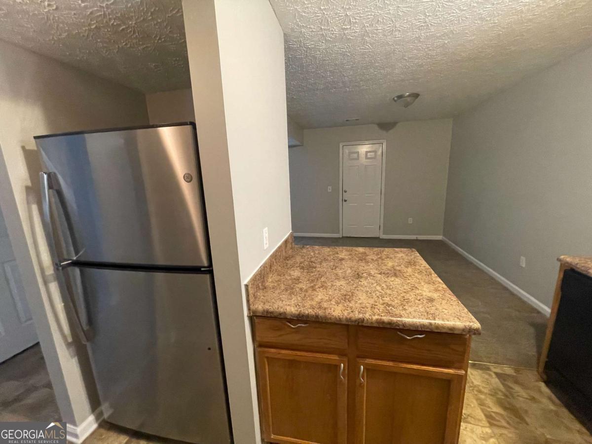 1374 To Lani Farm Road Stone Mountain, GA 30083 - Photo 9 of 18 a kitchen with a refrigerator and a stove