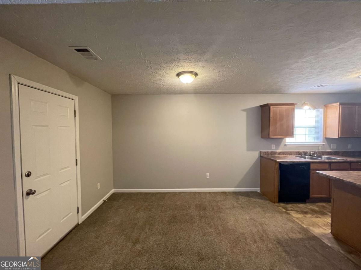 1374 To Lani Farm Road Stone Mountain, GA 30083 - Photo 10 of 18 a view of a kitchen with a sink and stove top oven