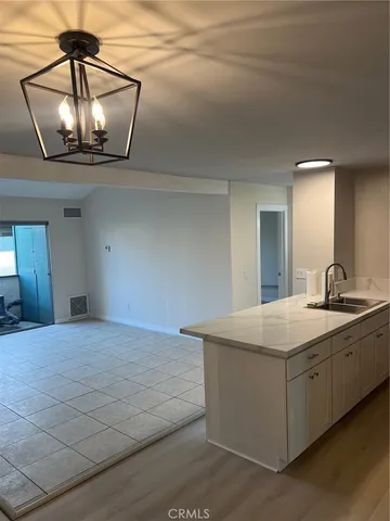 a room with a sink and chandelier