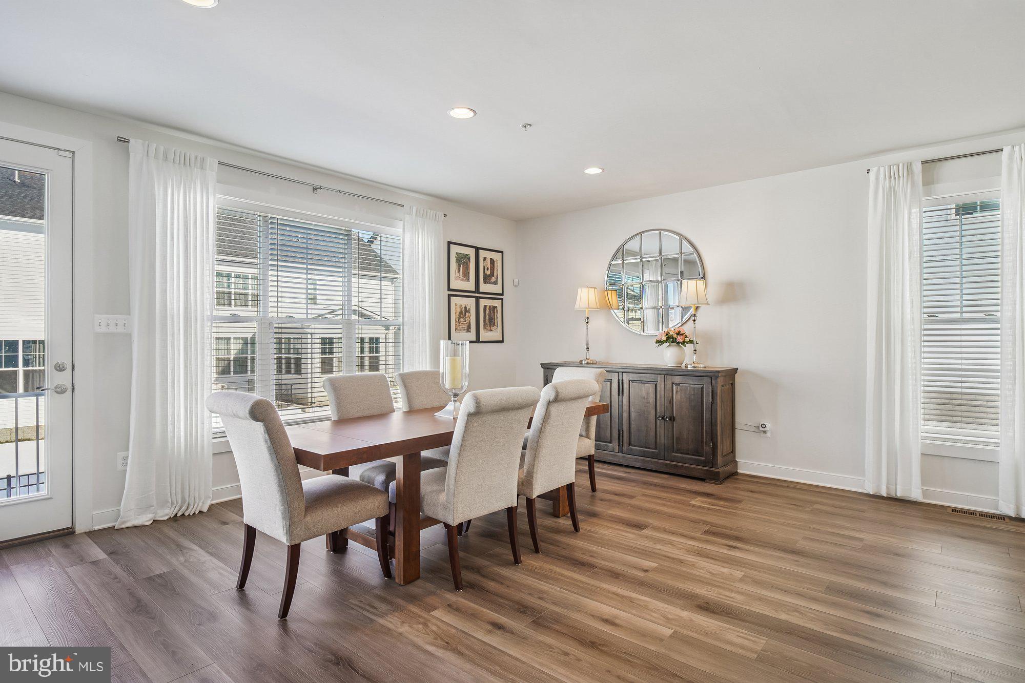 8776 Walnut Btm Lane Frederick, MD 21701 - Photo 13 of 39 a view of a dining room with furniture window and wooden floor