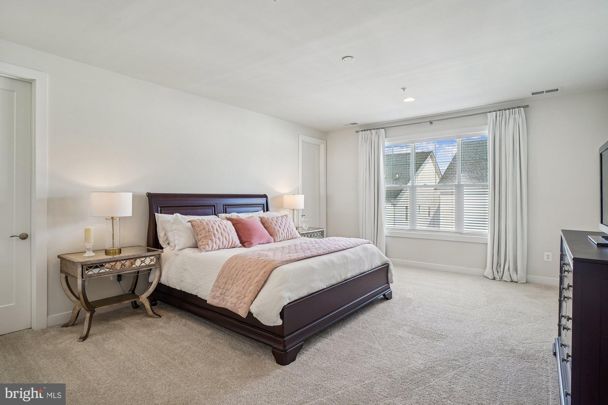 8776 Walnut Btm Lane Frederick, MD 21701 - Photo 18 of 39 a spacious bedroom with a bed and a window