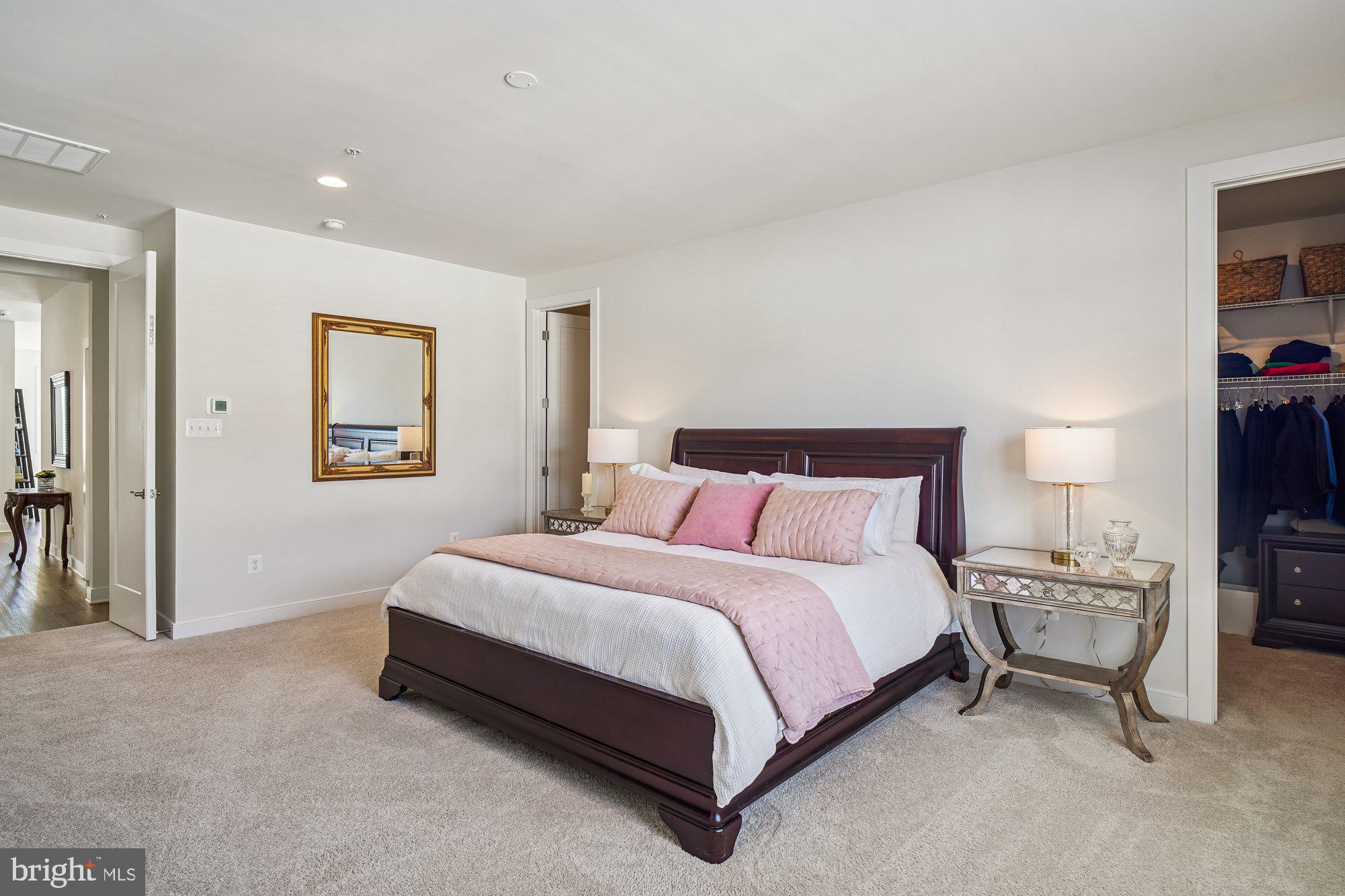 8776 Walnut Btm Lane Frederick, MD 21701 - Photo 19 of 39 a spacious bedroom with a bed and a cabinets