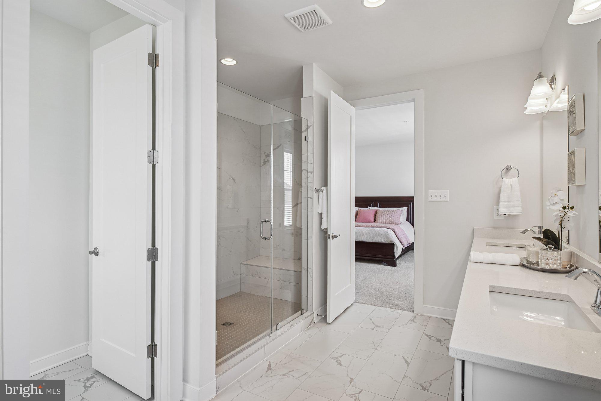 8776 Walnut Btm Lane Frederick, MD 21701 - Photo 22 of 39 a en suite bathroom with a sink a mirror and a shower