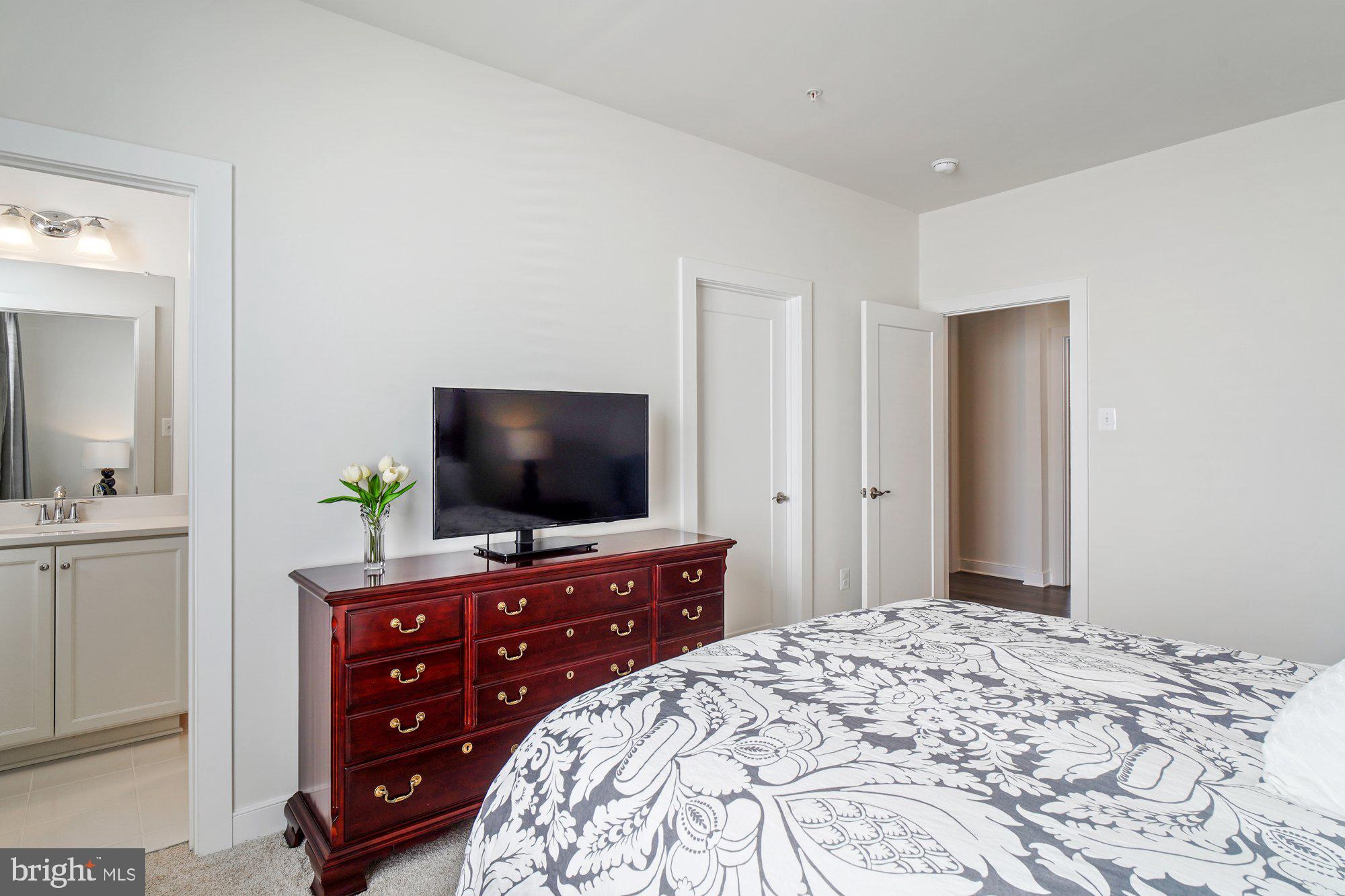 8776 Walnut Btm Lane Frederick, MD 21701 - Photo 24 of 39 a bedroom with a bed and a flat screen tv in it