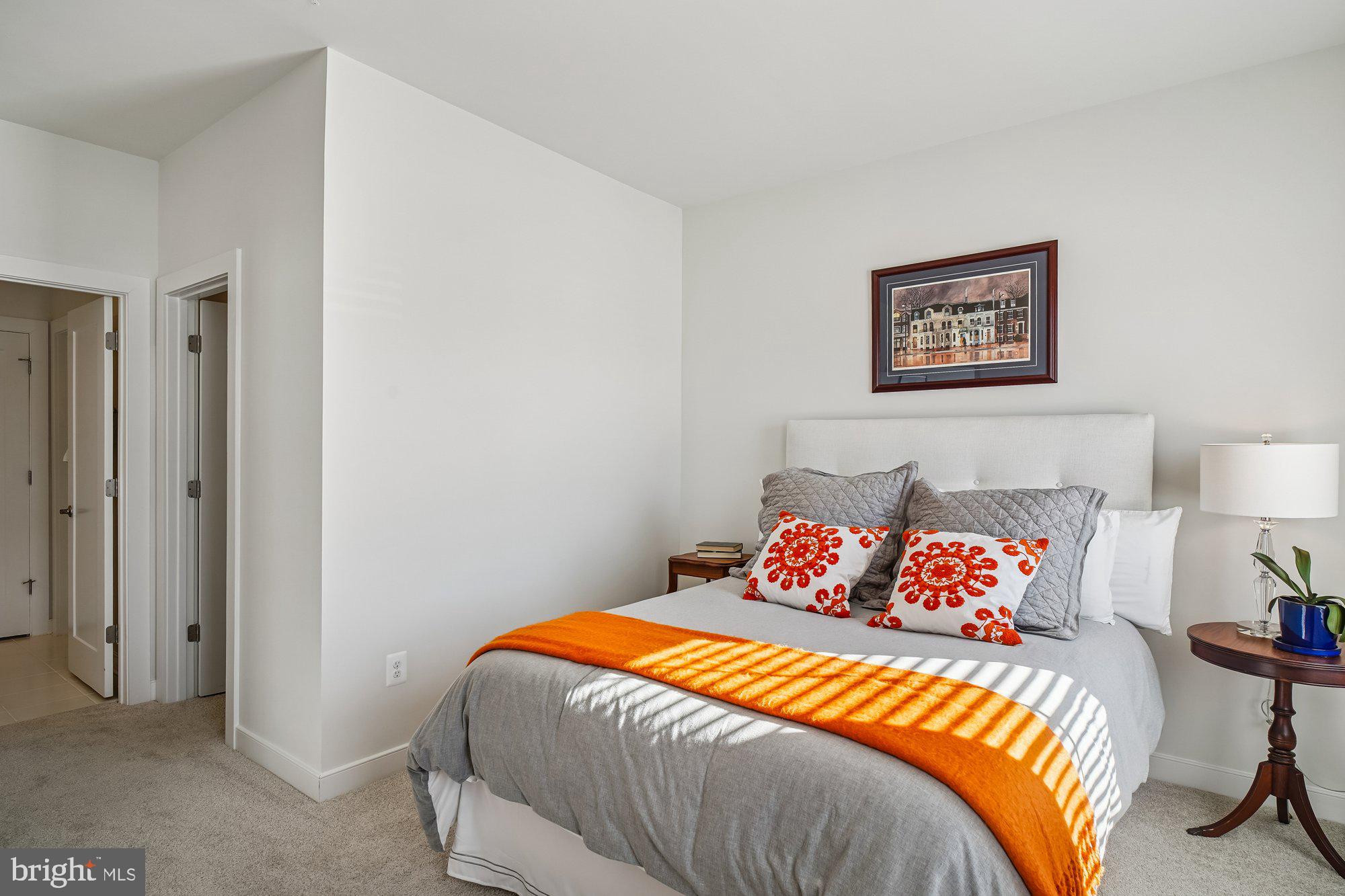 8776 Walnut Btm Lane Frederick, MD 21701 - Photo 27 of 39 a bedroom with a bed and a lamp on dresser