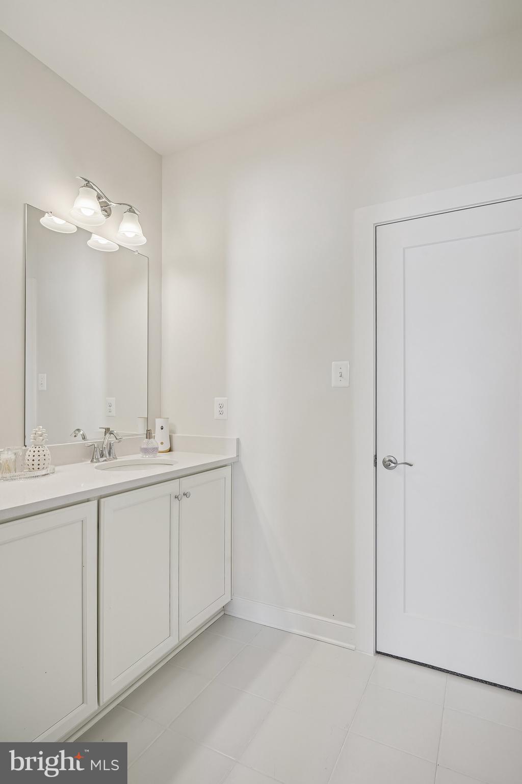 8776 Walnut Btm Lane Frederick, MD 21701 - Photo 28 of 39 a bathroom with a double vanity sink and mirror