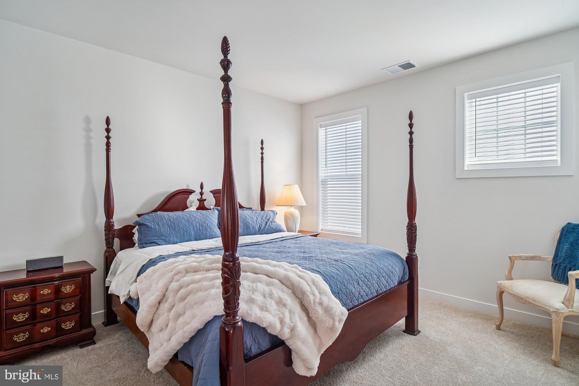 8776 Walnut Btm Lane Frederick, MD 21701 - Photo 29 of 39 a bedroom with a bed a couch and a window