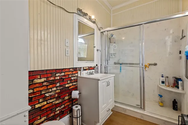 a view of a hallway with wooden floor and entryway