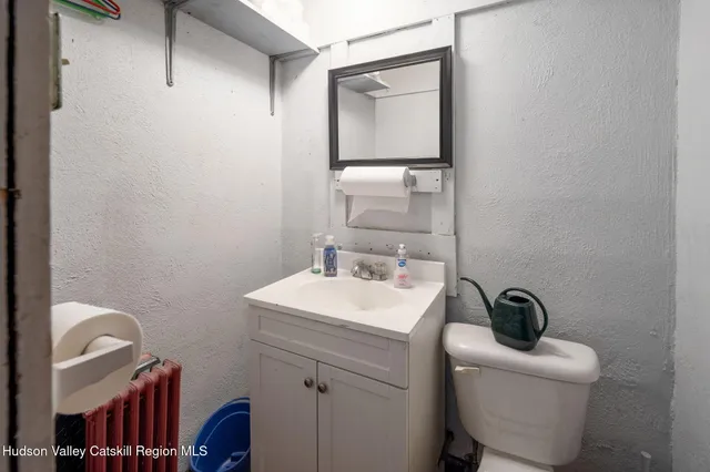 a bathroom with a sink a toilet and mirror