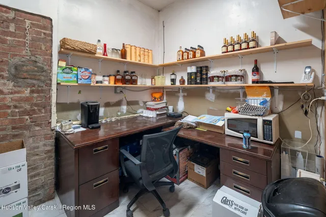 a room with stainless steel appliances a stove a sink and a refrigerator