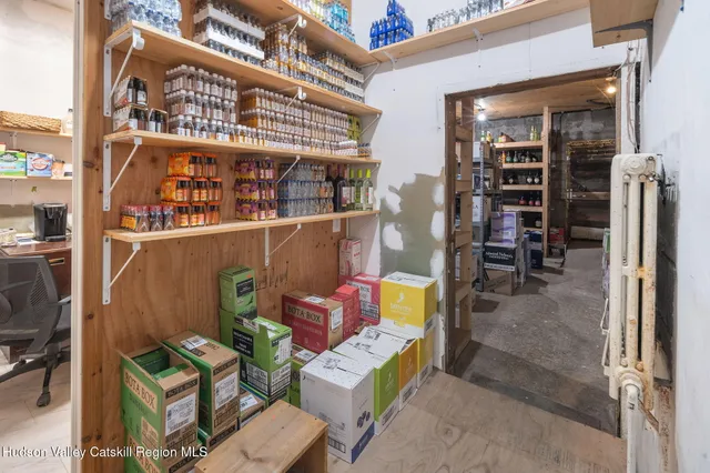 a cabinet in a room with lots of furniture and clutter
