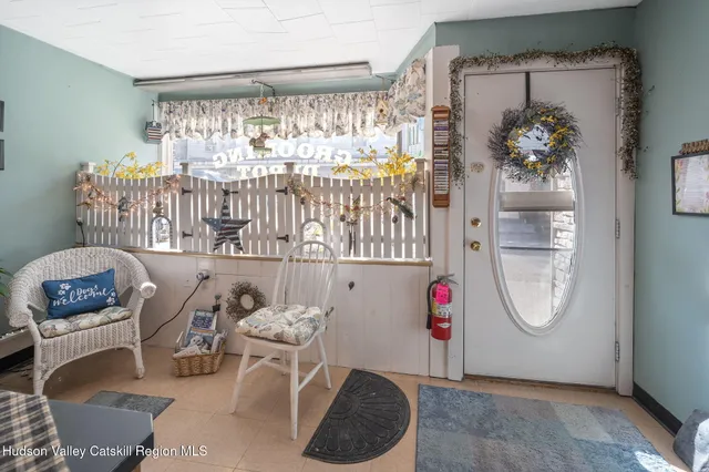a living room with furniture a couch and potted plant