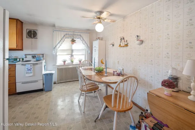 a kitchen with stainless steel appliances granite countertop a sink and a stove next to a window
