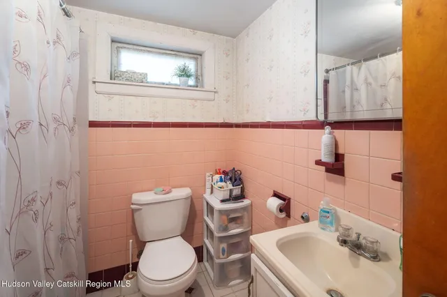 a white toilet sitting next to a bathroom sink