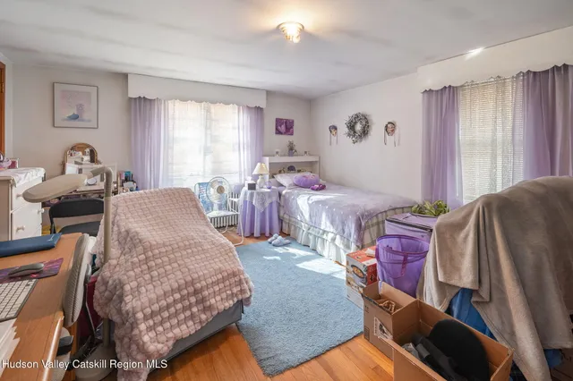 a bed room with a bed furniture and a flat screen tv