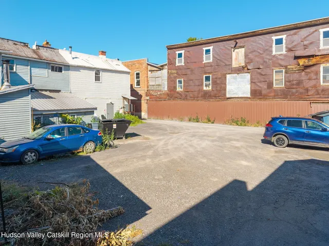 an aerial view of a house with a swimming pool patio and outdoor seating