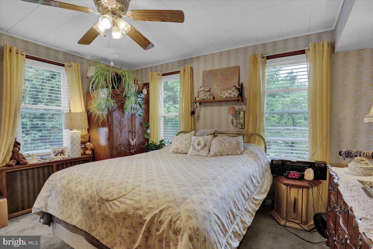1322 Brooke Boulevard Reading, PA 19607 - Photo 18 of 36 a bedroom with a bed and a chandelier