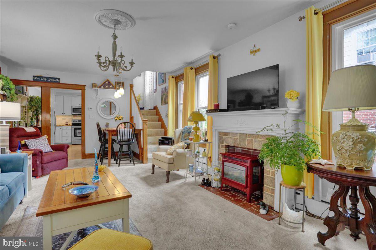 1322 Brooke Boulevard Reading, PA 19607 - Photo 7 of 36 a living room with furniture a fireplace and a flat screen tv