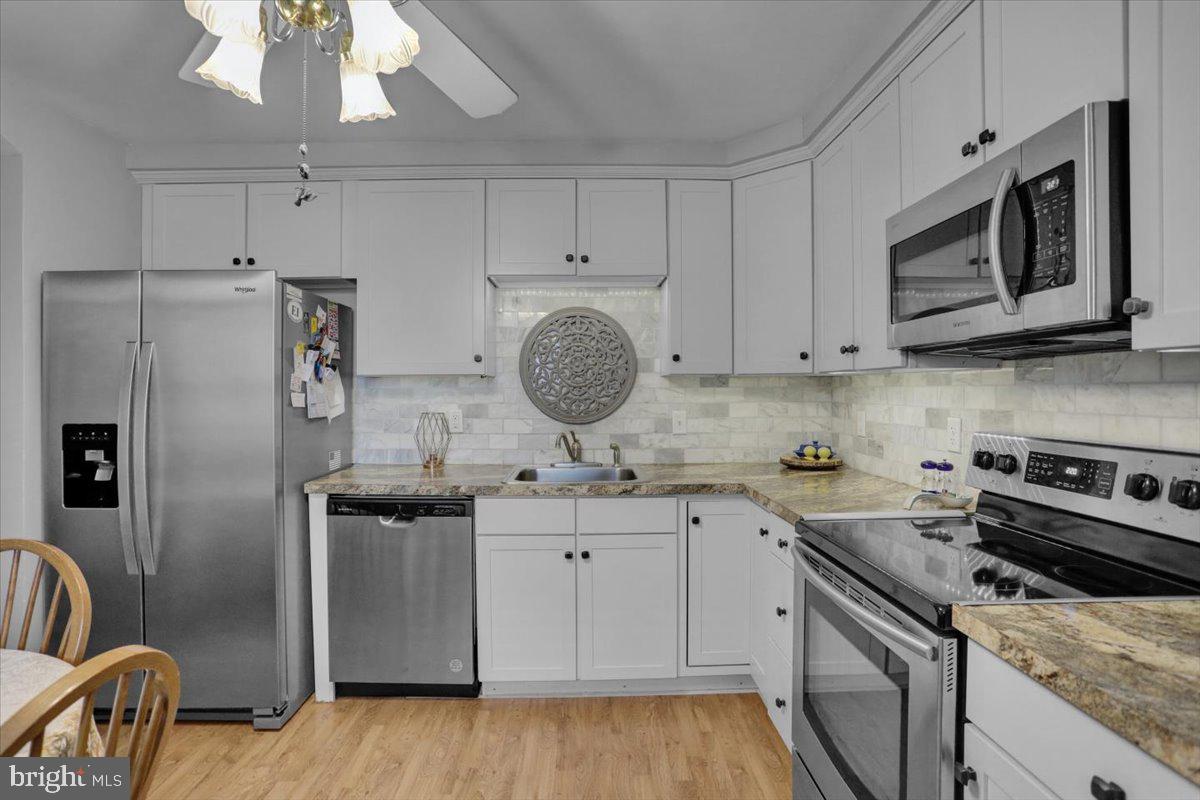 1322 Brooke Boulevard Reading, PA 19607 - Photo 10 of 36 a kitchen with stainless steel appliances granite countertop a sink stove and refrigerator