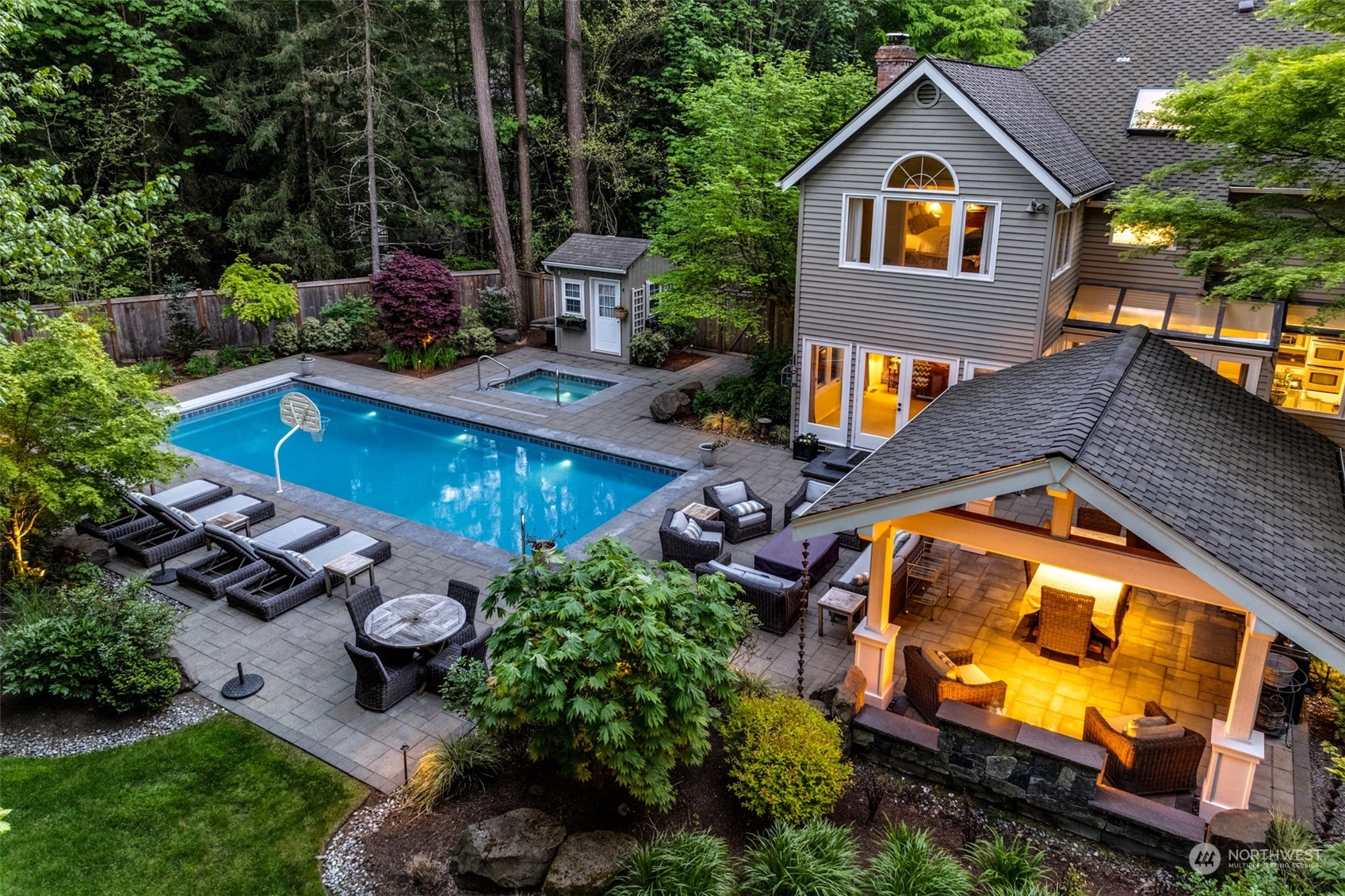 an aerial view of a house with swimming pool and outdoor seating