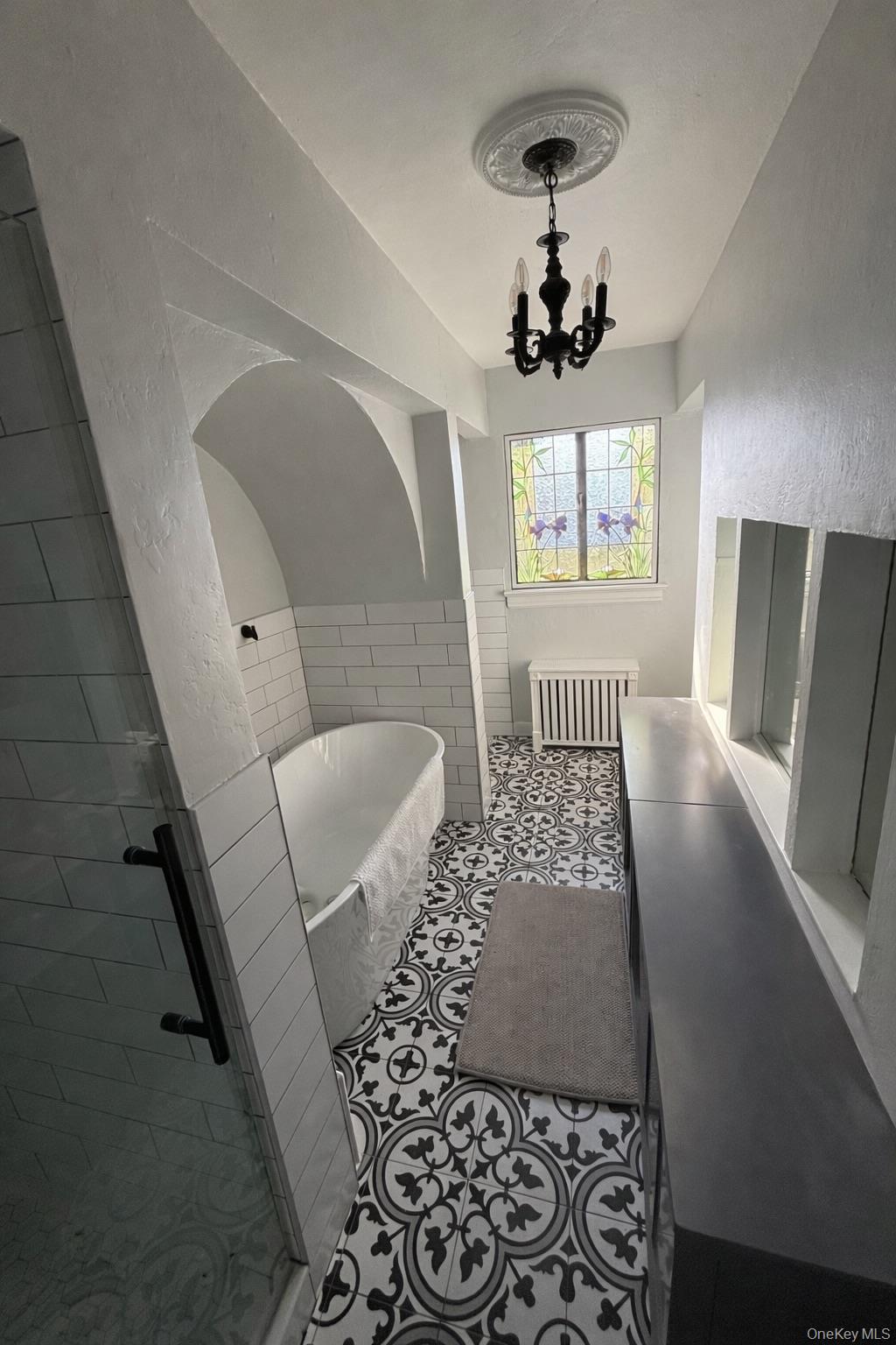 461 North Long Beach Road Rockville Centre, NY 11570 - Photo 13 of 14 Full bathroom with a textured wall, a freestanding tub, radiator, vanity, and wainscoting