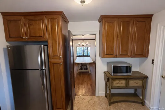 a kitchen with stainless steel appliances granite countertop a refrigerator and a cabinets