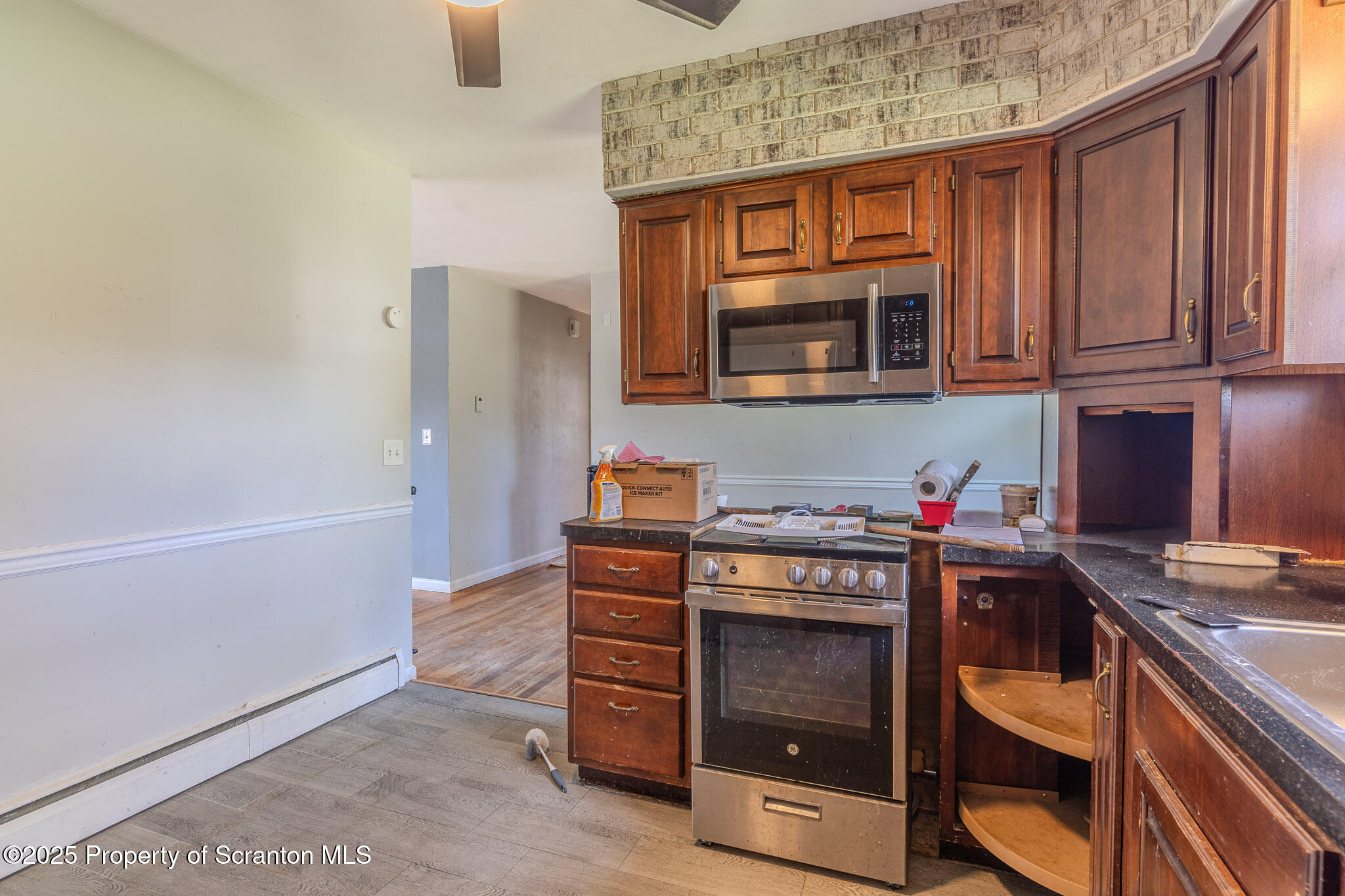 101 Sunset Road Dalton, PA 18414 - Photo 14 of 37 a kitchen with stainless steel appliances granite countertop a stove and a microwave