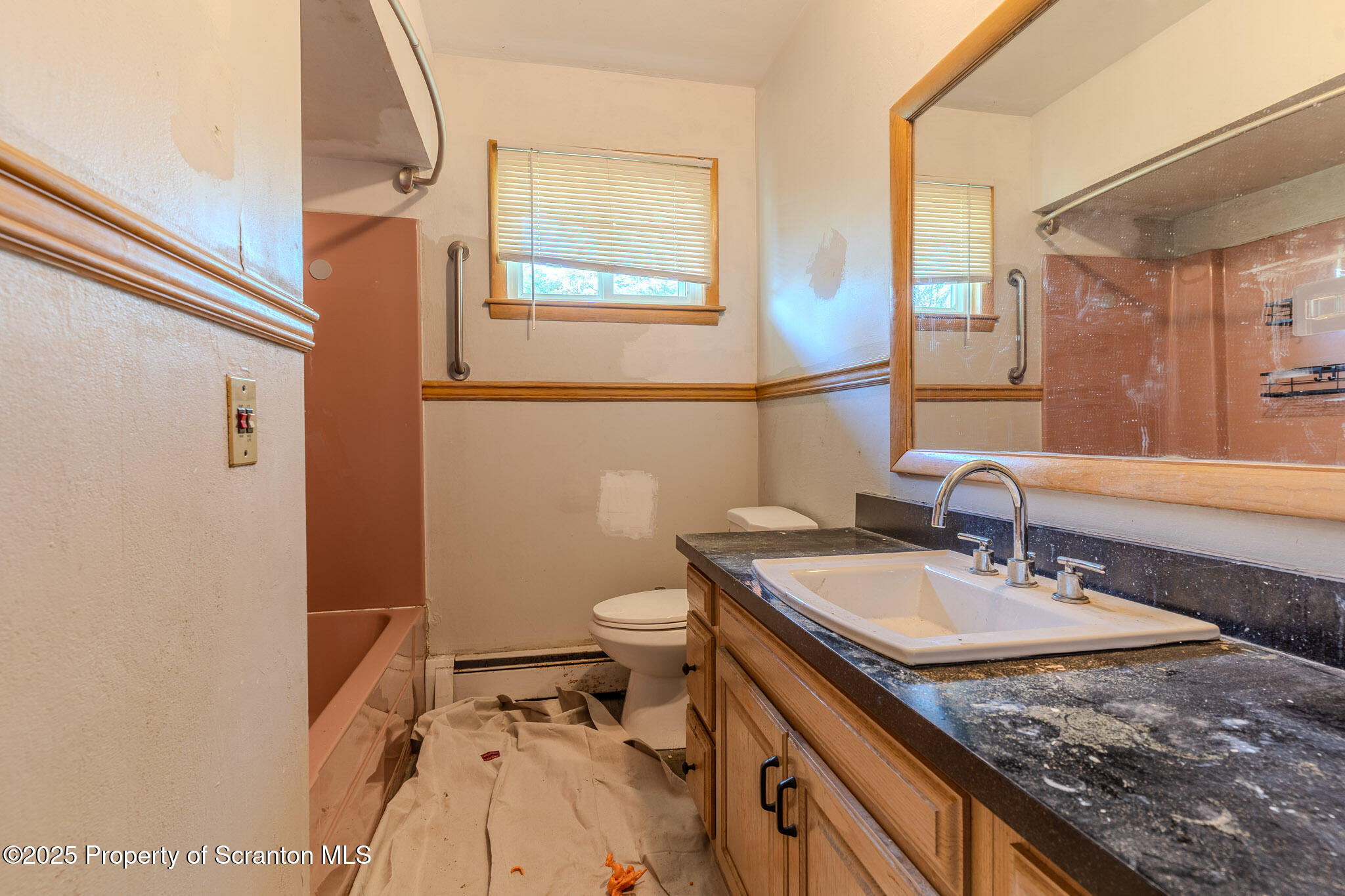 101 Sunset Road Dalton, PA 18414 - Photo 15 of 37 a bathroom with a granite countertop sink a toilet and a mirror