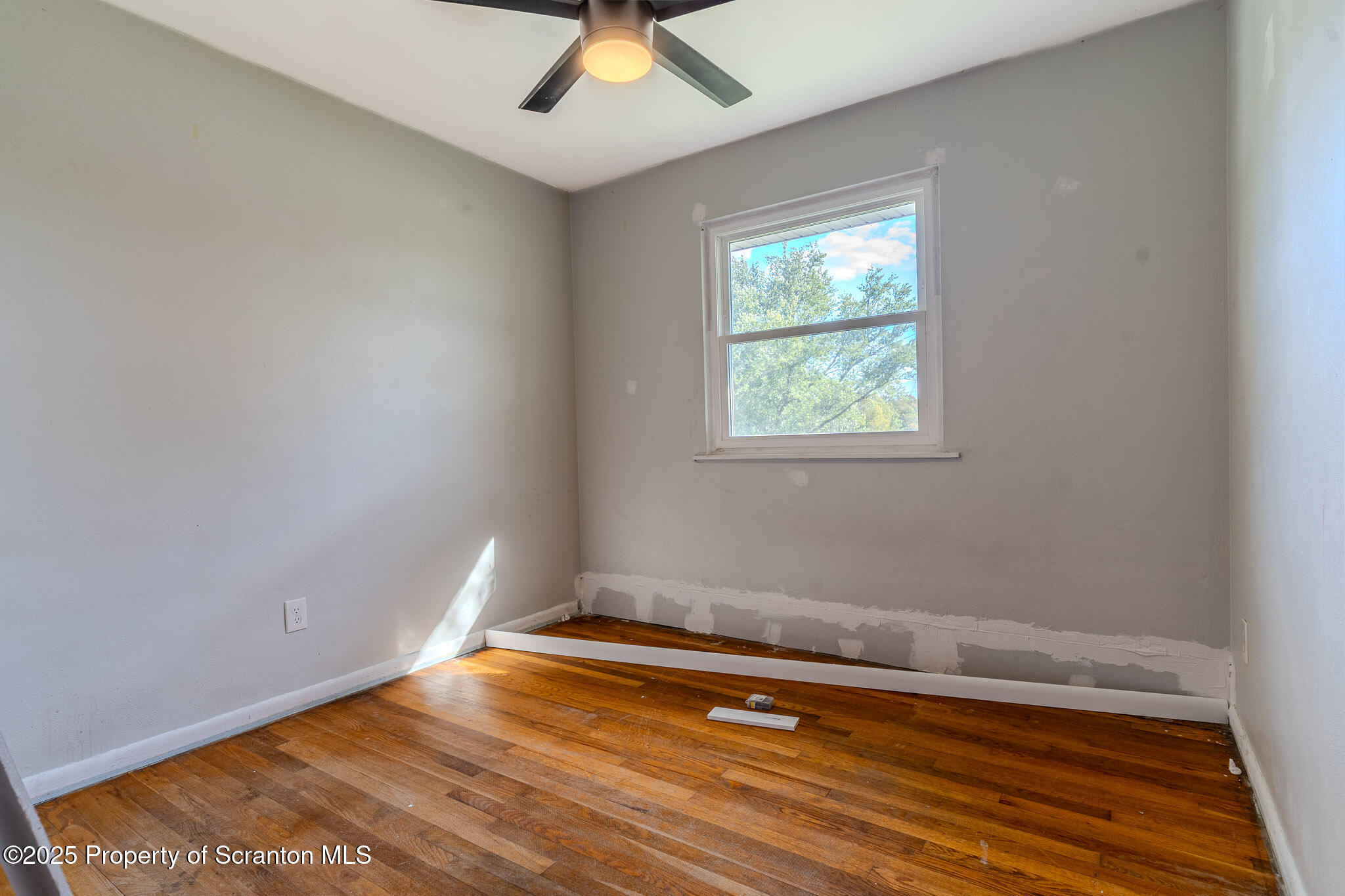 101 Sunset Road Dalton, PA 18414 - Photo 16 of 37 an empty room with wooden floor and windows