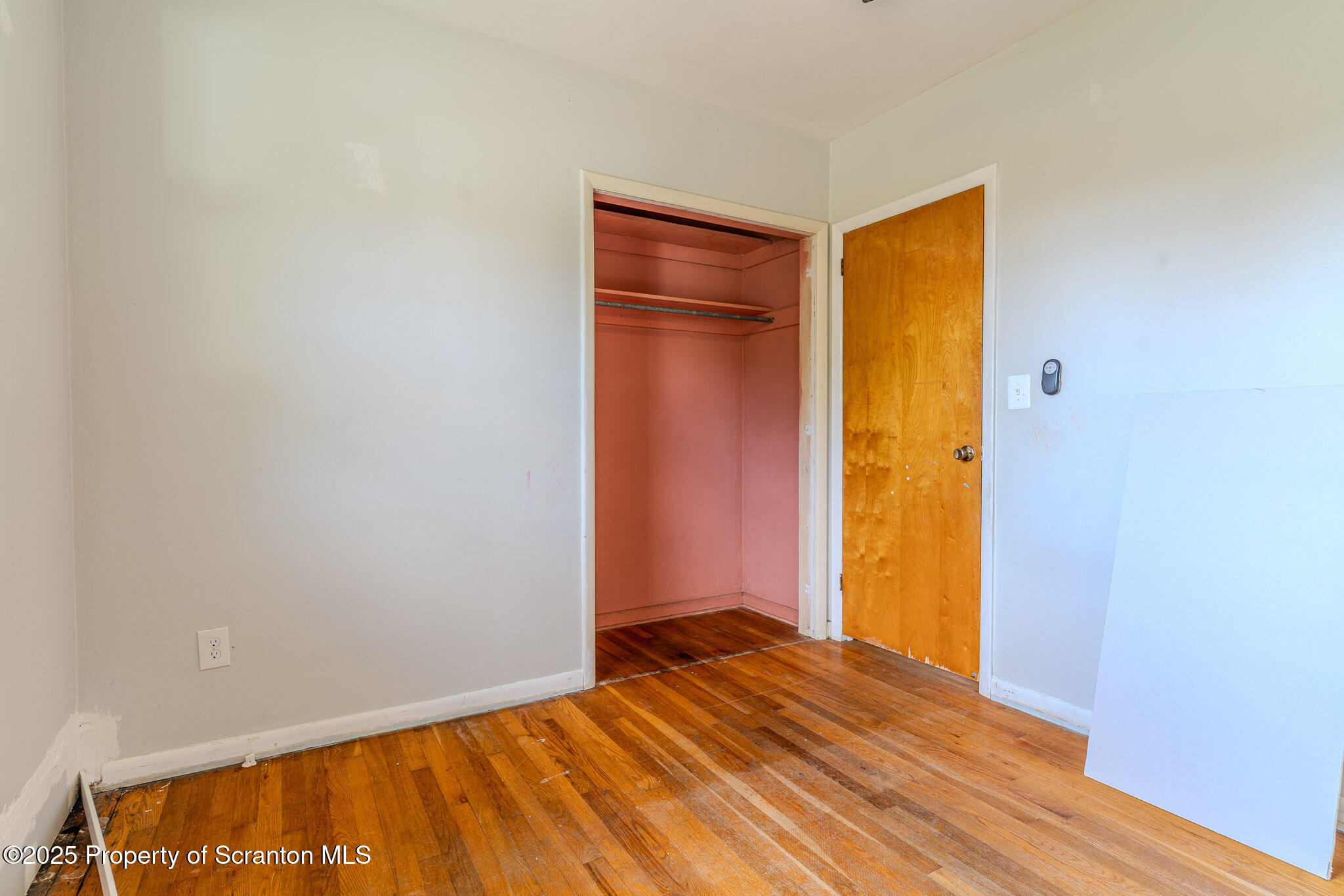 101 Sunset Road Dalton, PA 18414 - Photo 17 of 37 a view of an empty room with closet and wooden floor