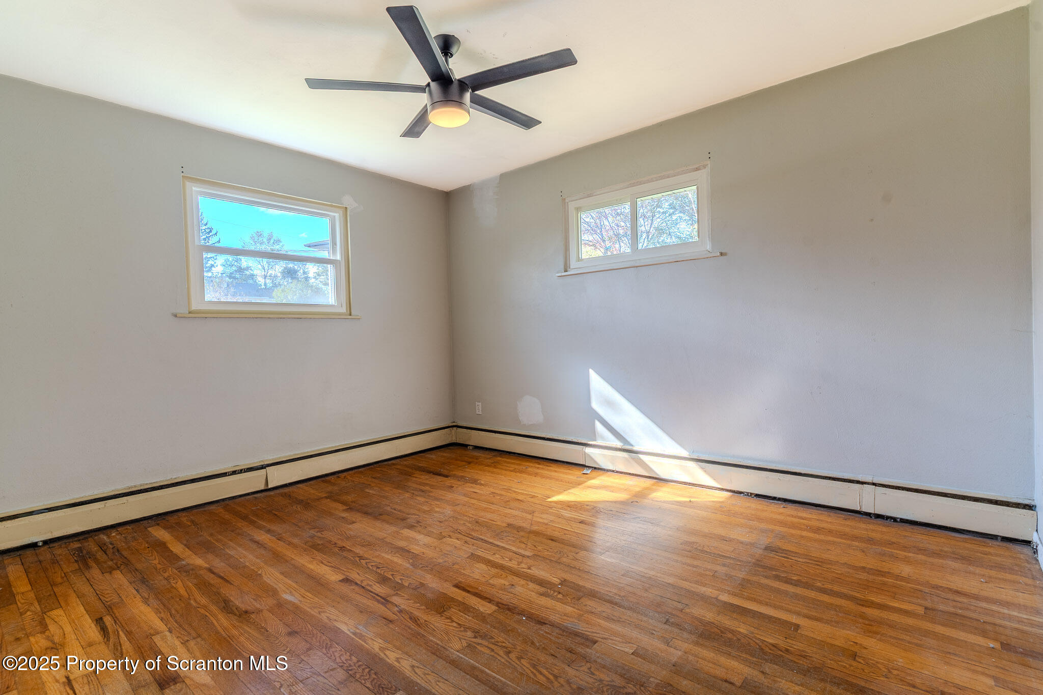 101 Sunset Road Dalton, PA 18414 - Photo 18 of 37 a view of an empty room with window and wooden floor