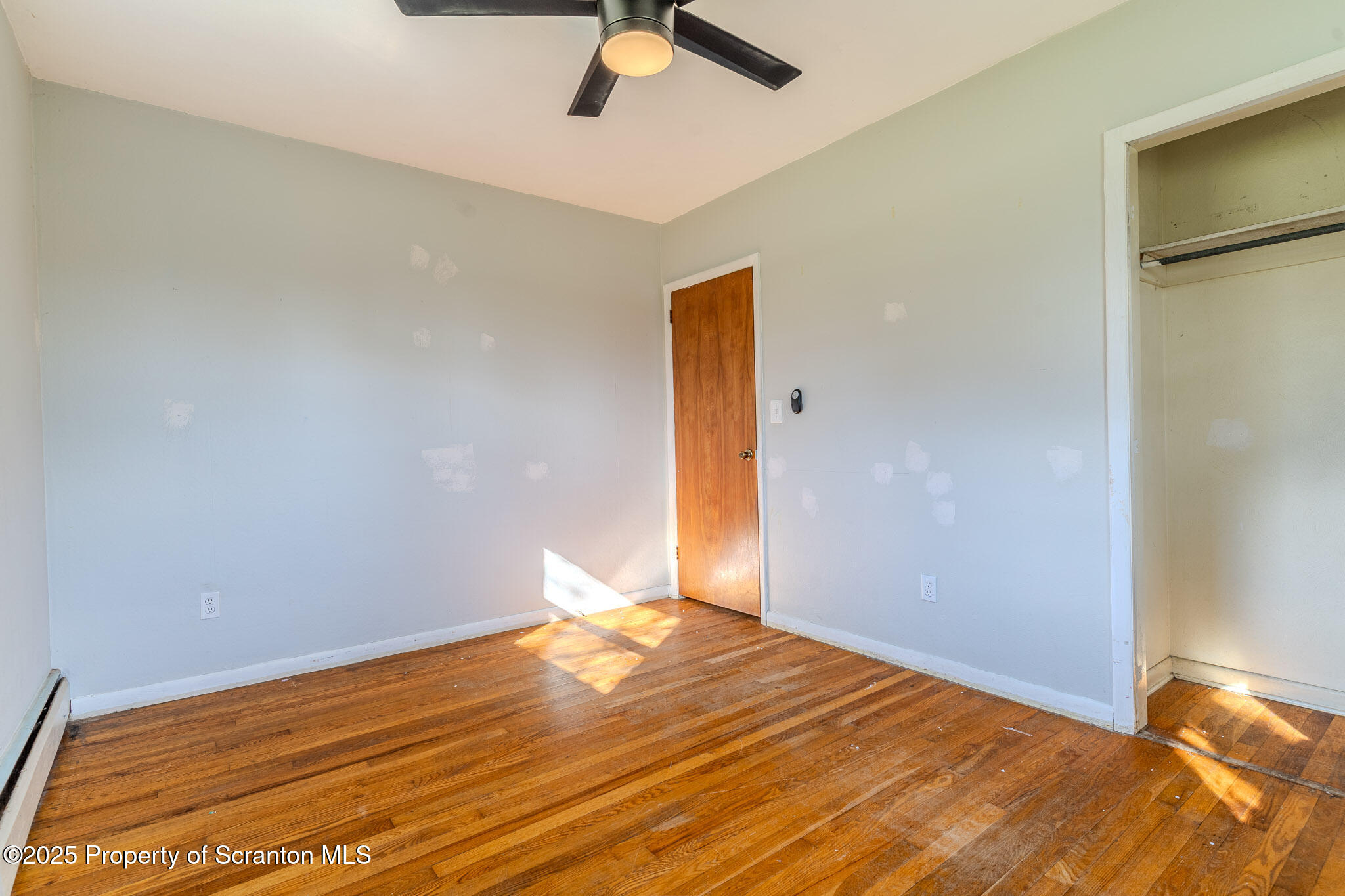 101 Sunset Road Dalton, PA 18414 - Photo 21 of 37 a view of a room with wooden floor and a ceiling fan