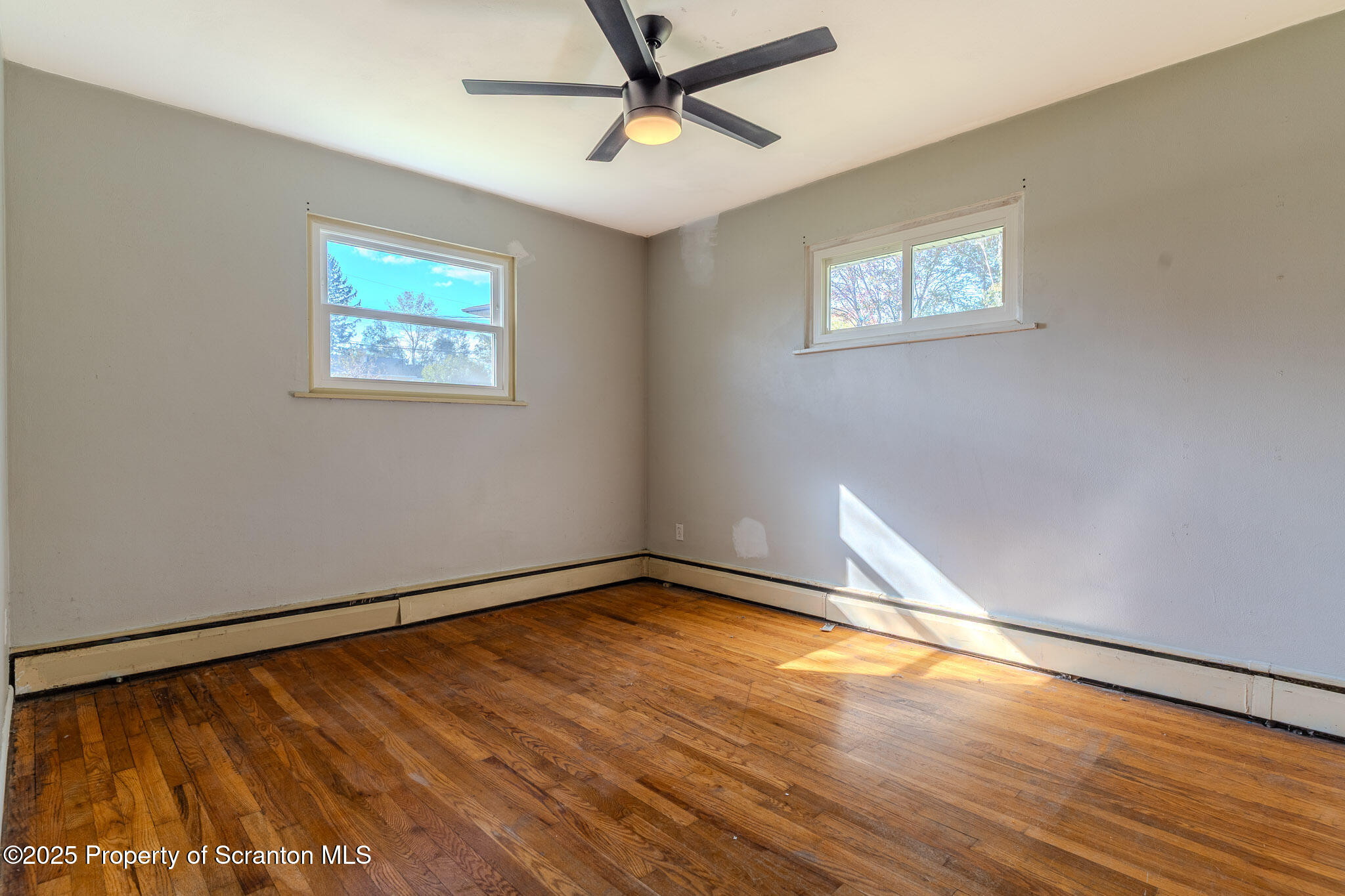 101 Sunset Road Dalton, PA 18414 - Photo 22 of 37 a view of an empty room with wooden floor and a window