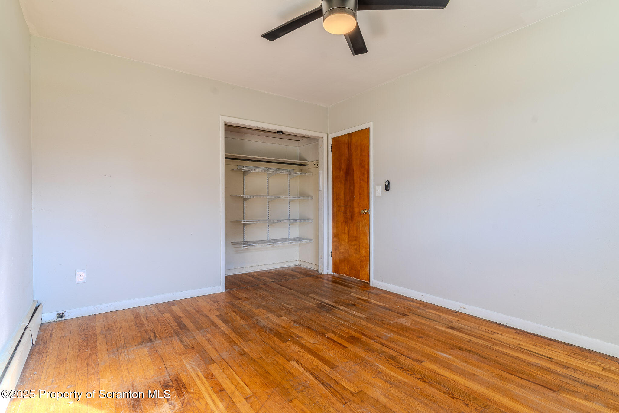 101 Sunset Road Dalton, PA 18414 - Photo 23 of 37 an empty room with wooden floor fan and windows