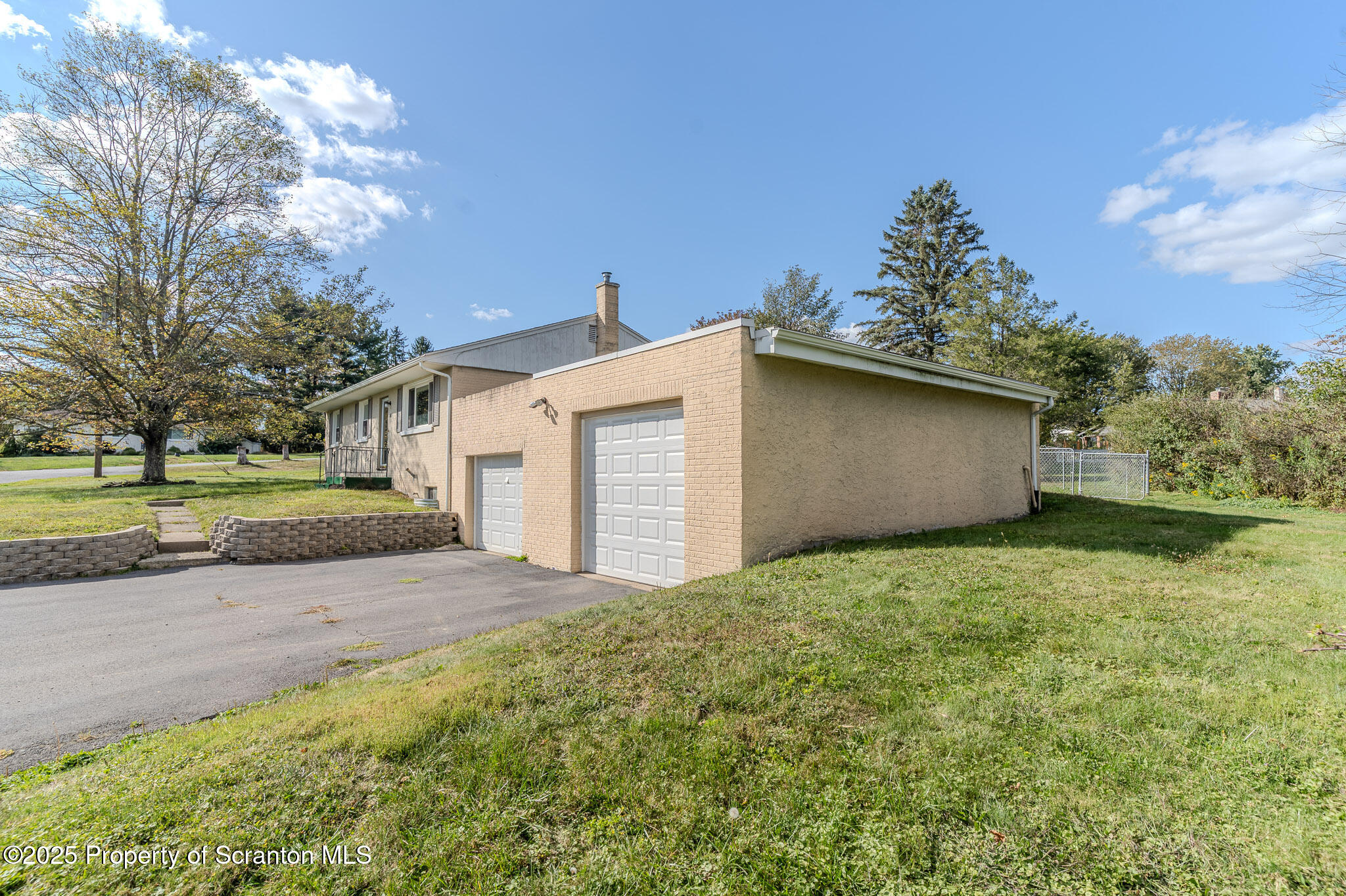 101 Sunset Road Dalton, PA 18414 - Photo 4 of 37 a view of a house with a yard and garage