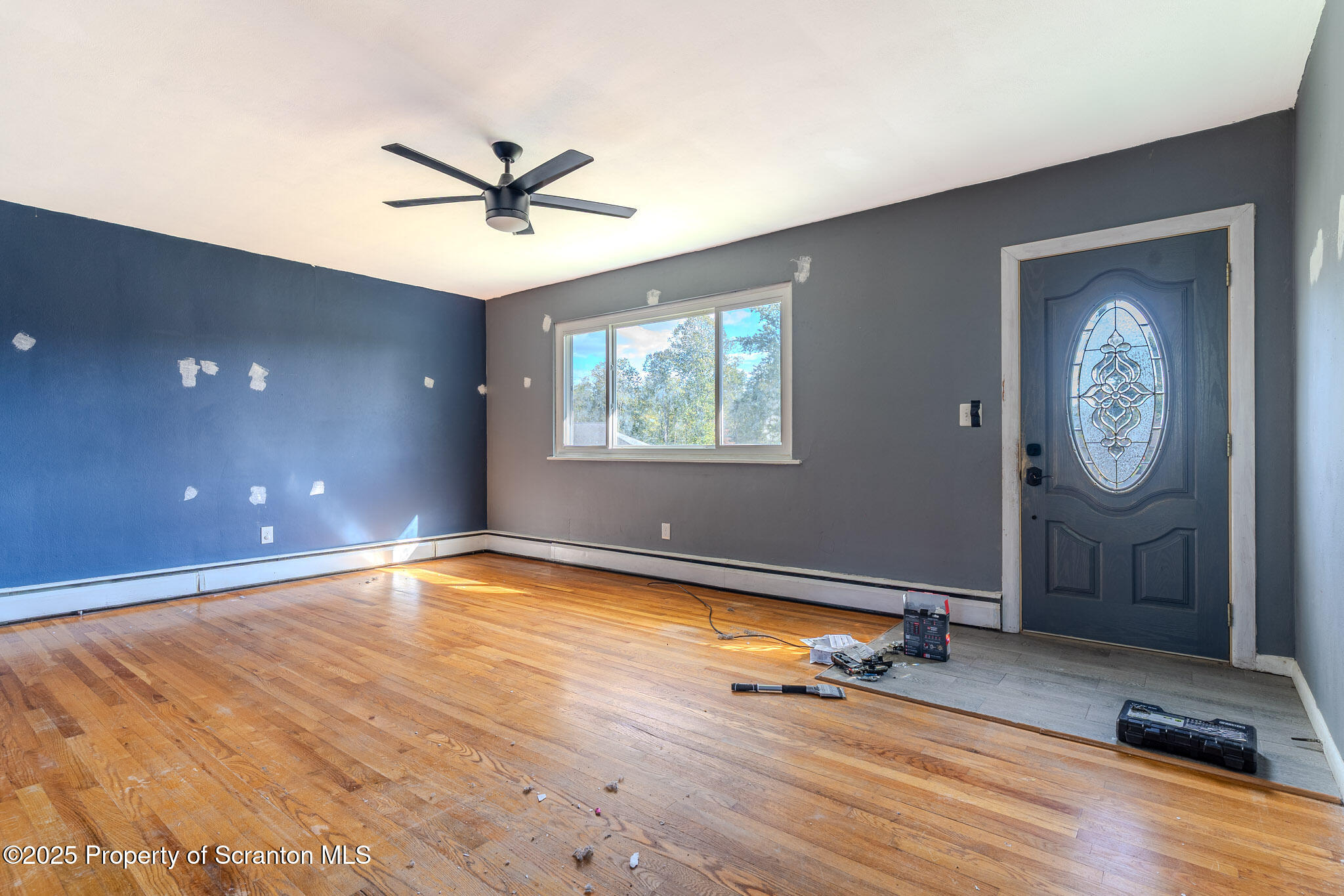 101 Sunset Road Dalton, PA 18414 - Photo 7 of 37 a view of a livingroom with a hardwood floor and a ceiling fan