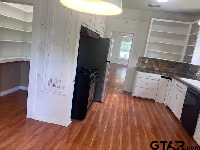 617 West Dobbs Street Tyler, TX 75701 - Photo 9 of 19 a kitchen with a refrigerator and wooden floor