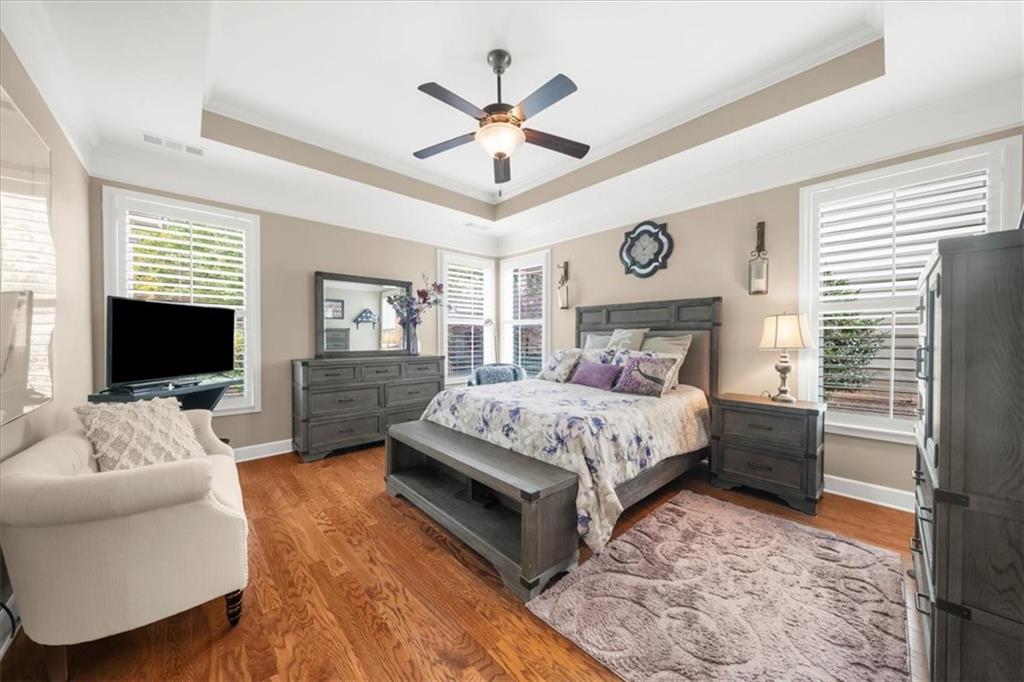 3880 Sweet Magnolia Drive Southwest Gainesville, GA 30504 - Photo 20 of 56 a bedroom with a bed a couch and a flat screen tv