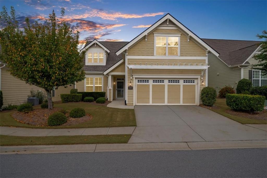 3880 Sweet Magnolia Drive Southwest Gainesville, GA 30504 - Photo 2 of 56 a front view of a house with a yard and garage