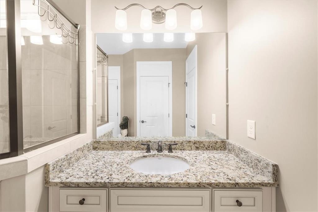 3880 Sweet Magnolia Drive Southwest Gainesville, GA 30504 - Photo 22 of 56 a bathroom with a granite countertop sink and a mirror