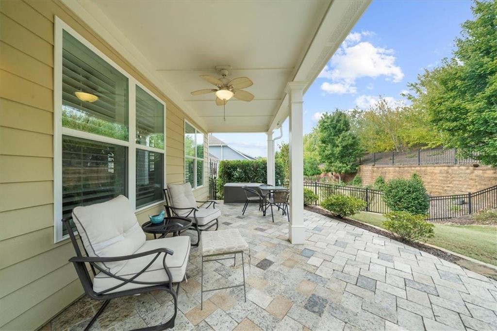 3880 Sweet Magnolia Drive Southwest Gainesville, GA 30504 - Photo 27 of 56 a view of a patio with table and chairs and floor to ceiling window